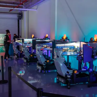 A row of SimsForHire racing simulators set up inside Miami International Autodrome
