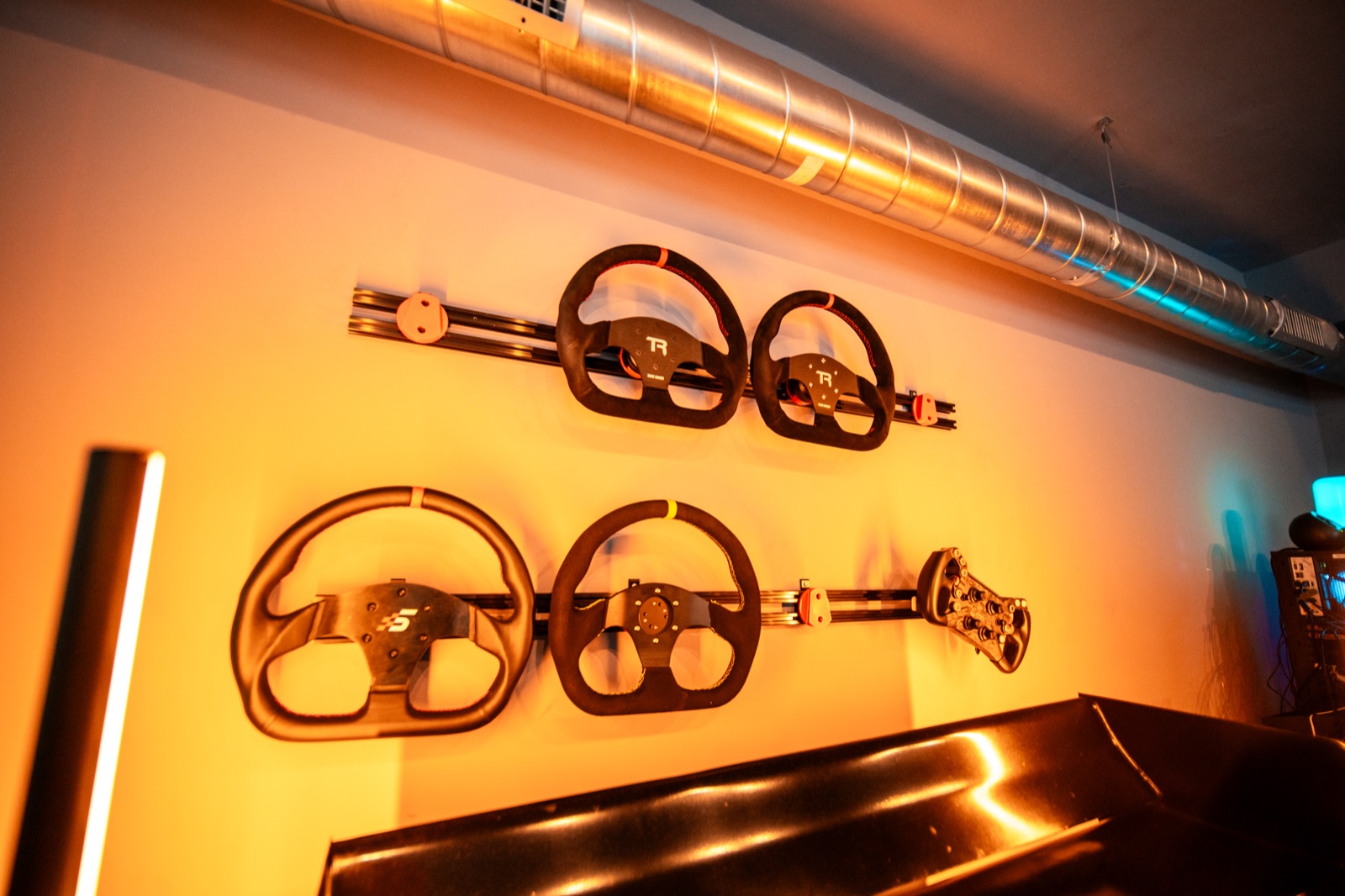 Full-motion racing simulator rig with triple screens in Gulf Stream