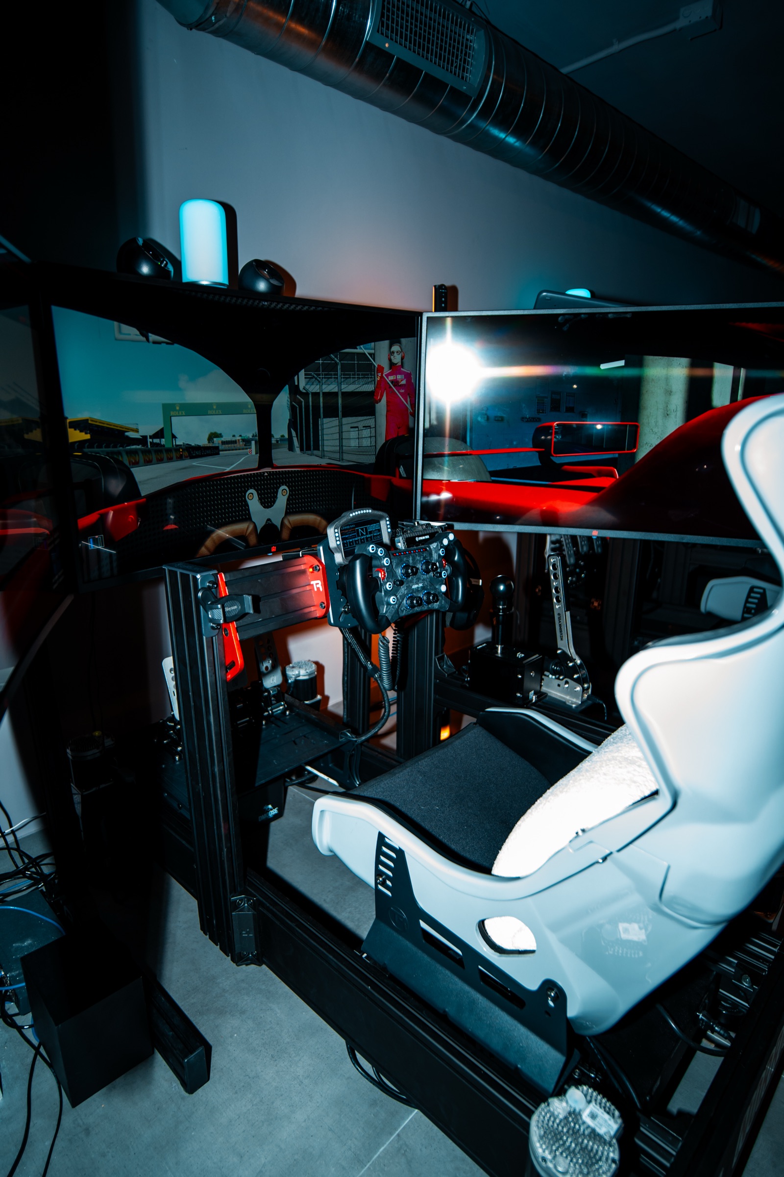 Full-motion racing simulator rig with triple screens in Margate