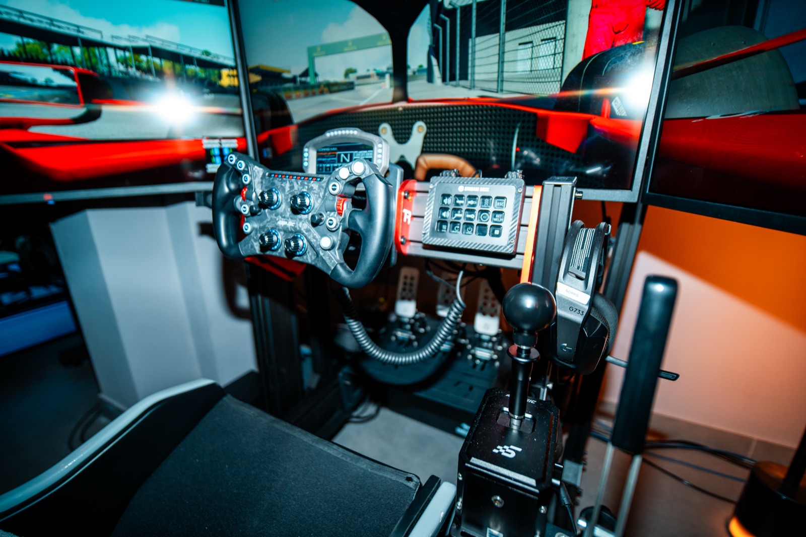 Full-motion racing simulator rig with triple screens in Juno Beach