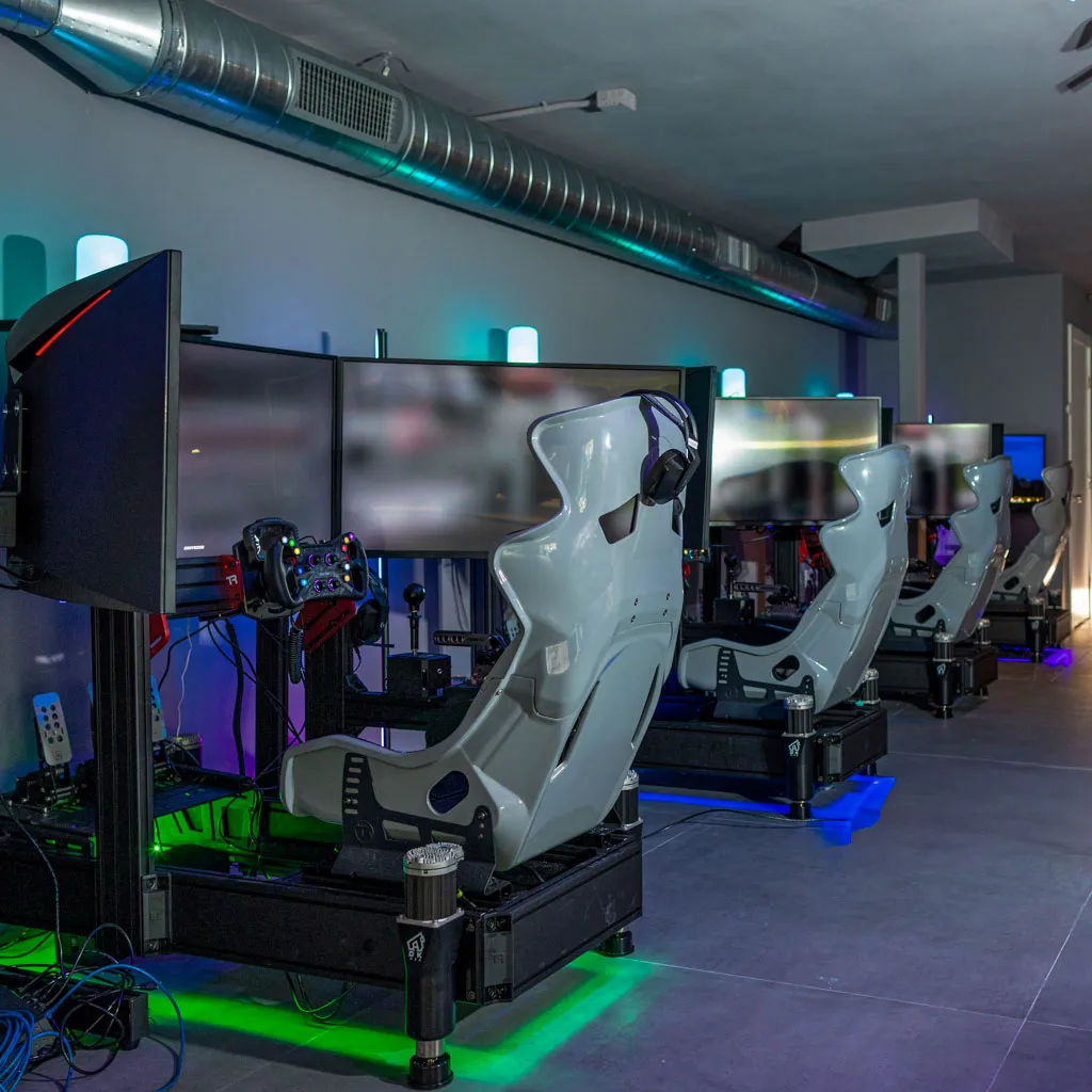 A row of four full-motion racing simulators