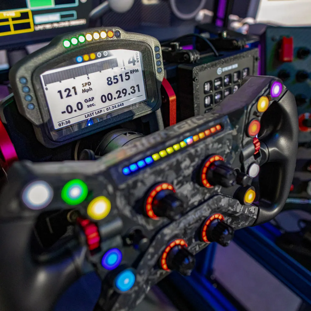 Sim racing wheel and dash showing speed, RPM and lap time